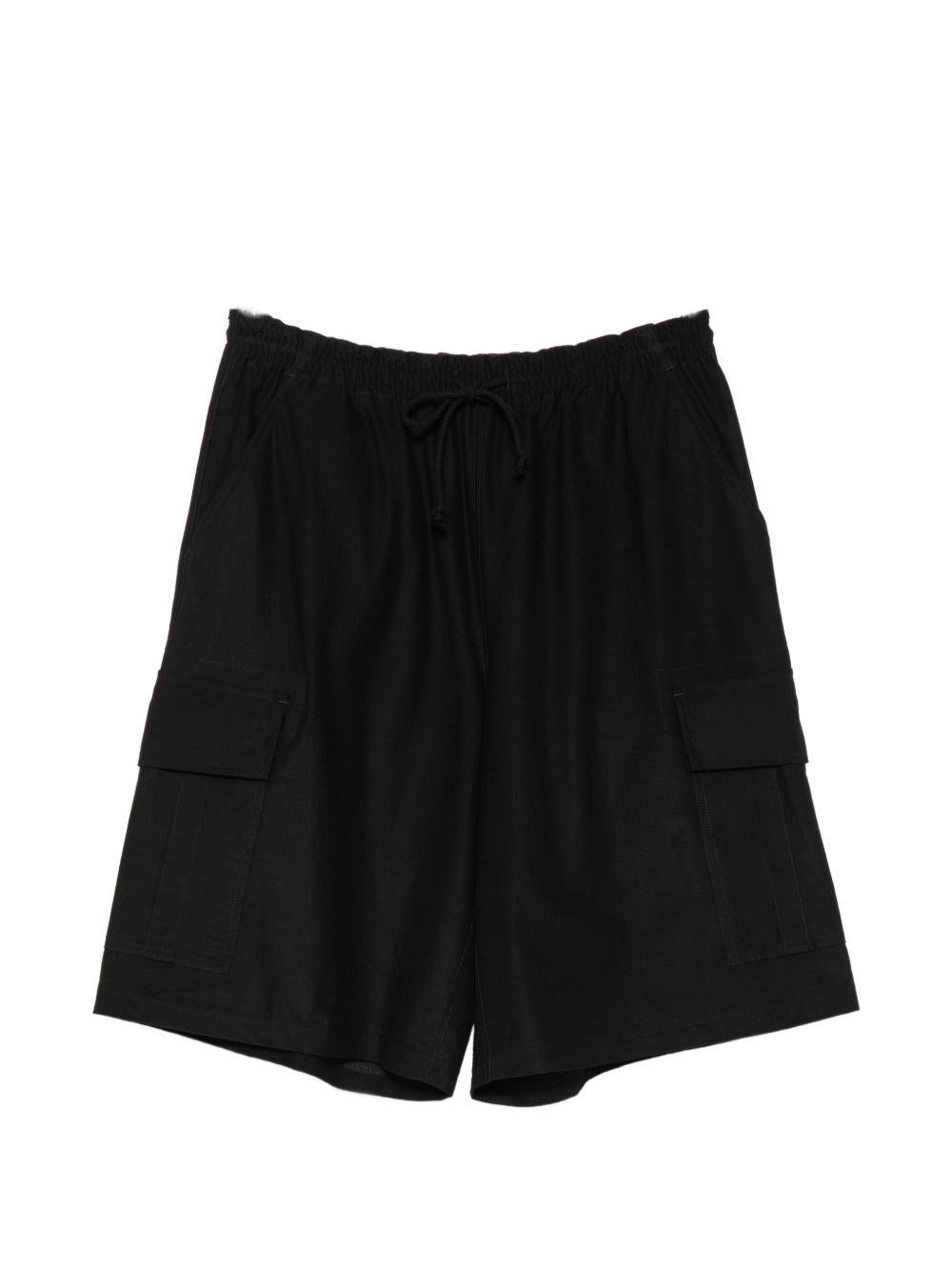 Pantaloncini cargo con coulisse in nero Comme des garcons homme - uomo 