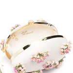 Clutch ovale con fiori in crema 