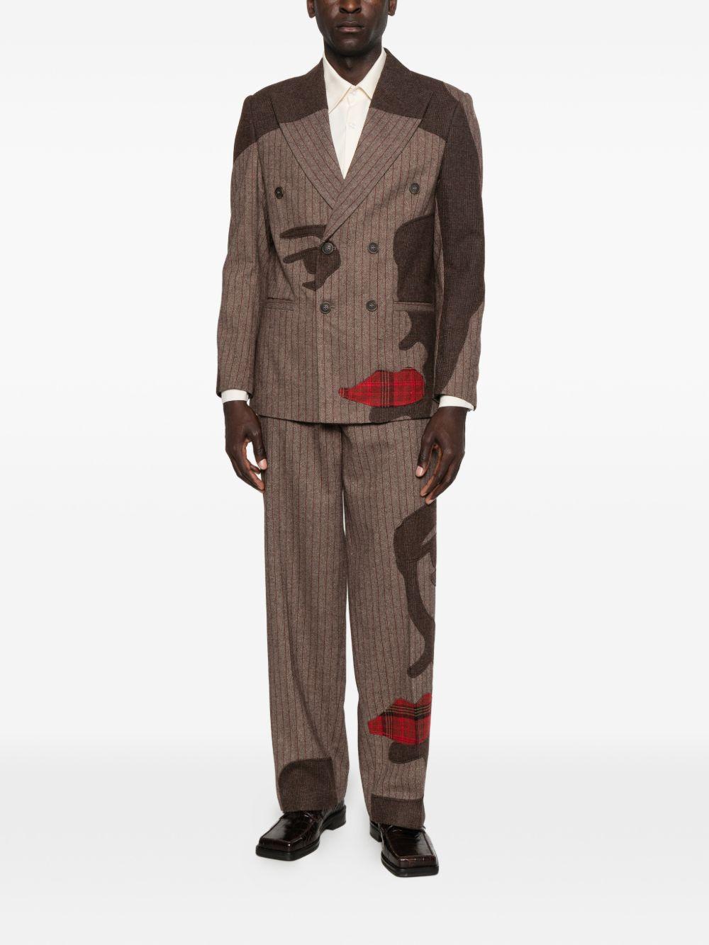Pantaloni a righe con design patchwork  in marrone Kidsuper - uomo 