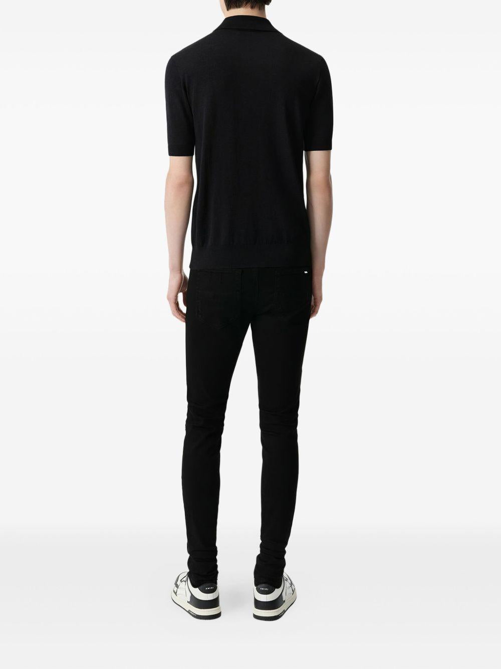 Jeans MX1 con strappi in nero 