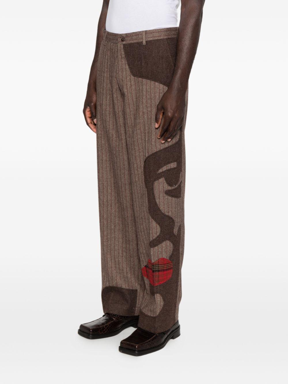 Pantaloni a righe con design patchwork  in marrone Kidsuper - uomo 