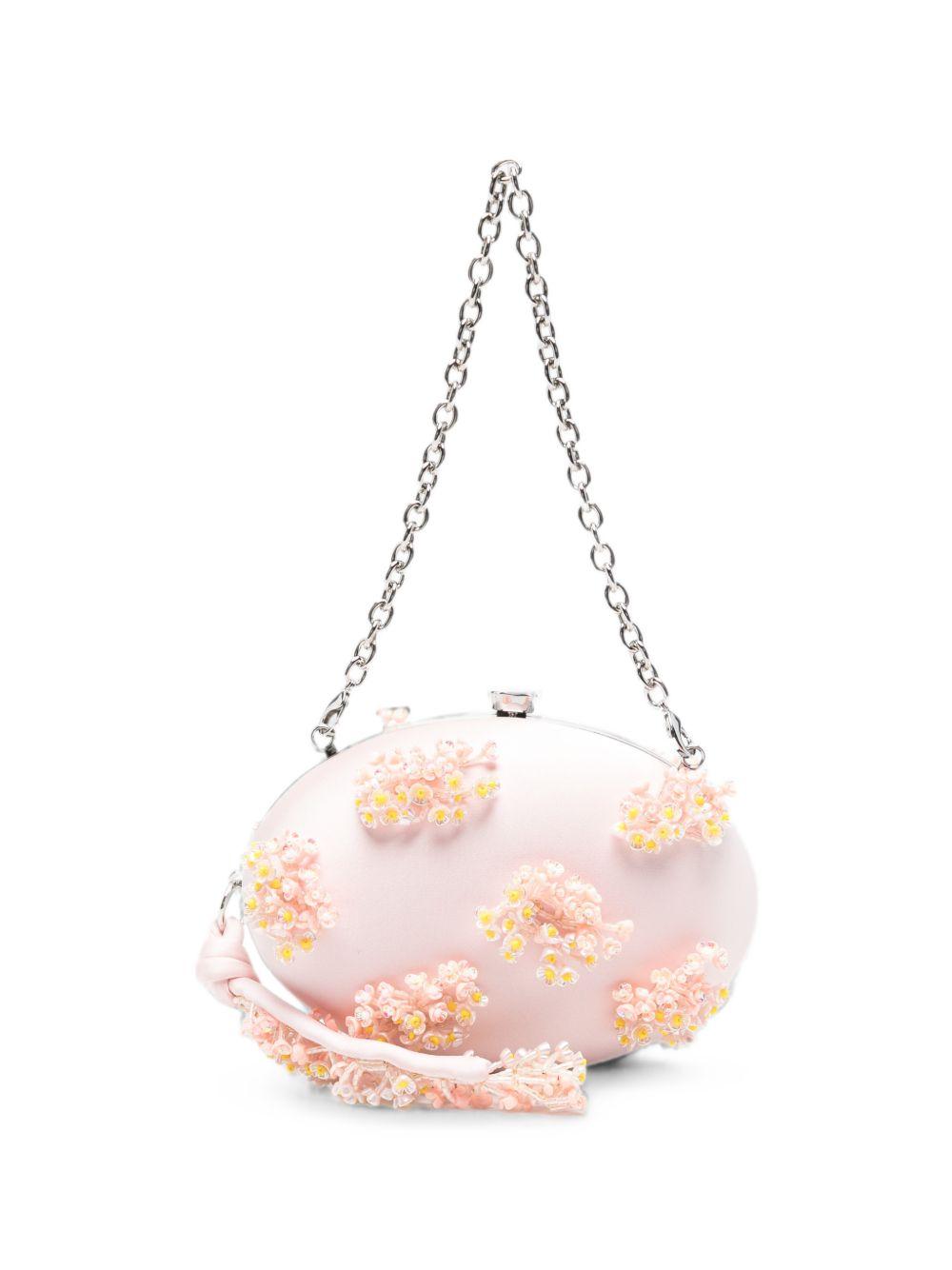 Clutch in raso rosa con decorazioni floreali 