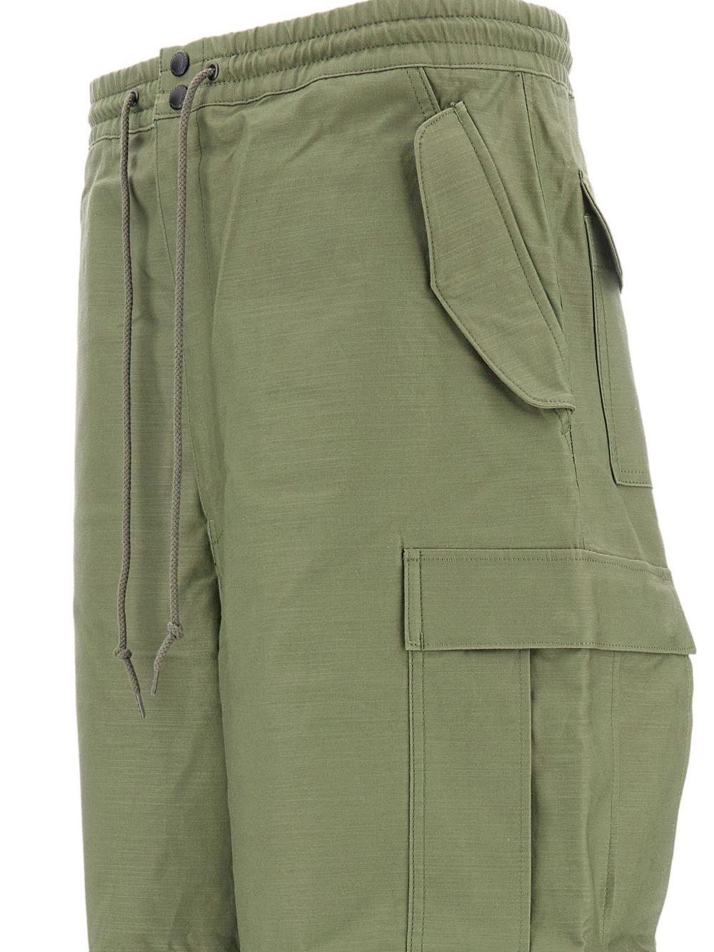 Pantaloni con tasche cargo in verde Junya watanabe - uomo 