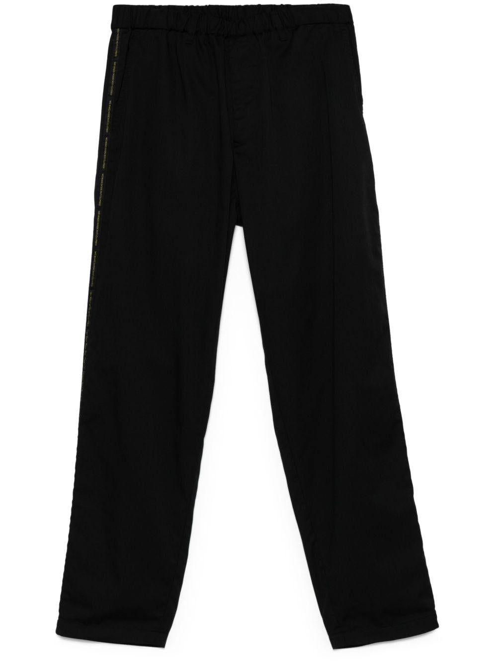 Pantaloni con banda logo in nero Undercover - uomo 