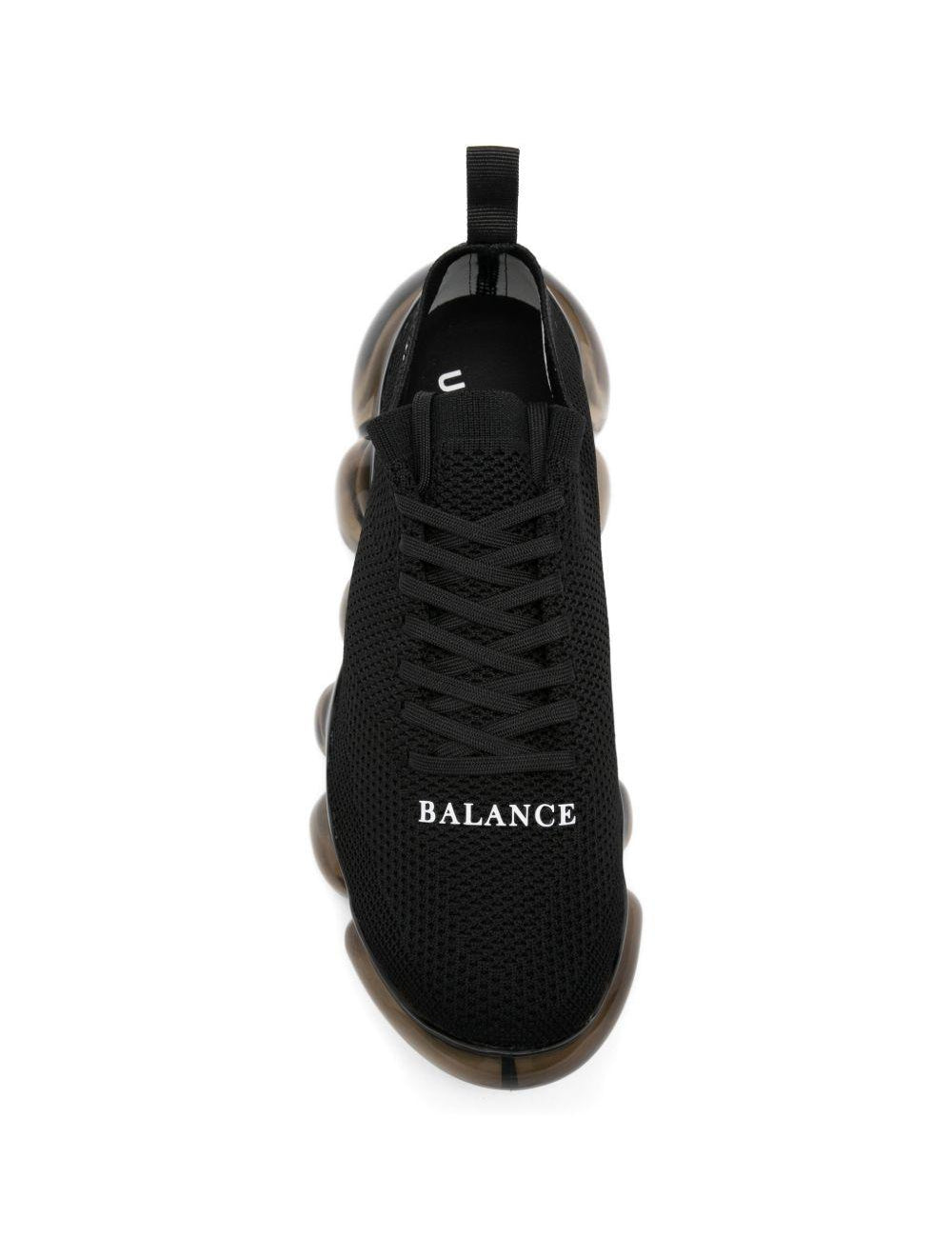 Sneakers con suola a bolle in nero Undercover - uomo 