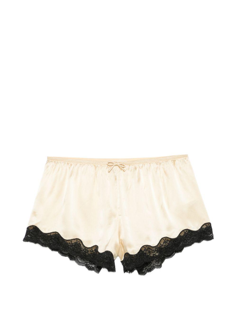 Pantaloncini con bordo in pizzo e fiocco decorativo in beige Rotate x love stories - donna 