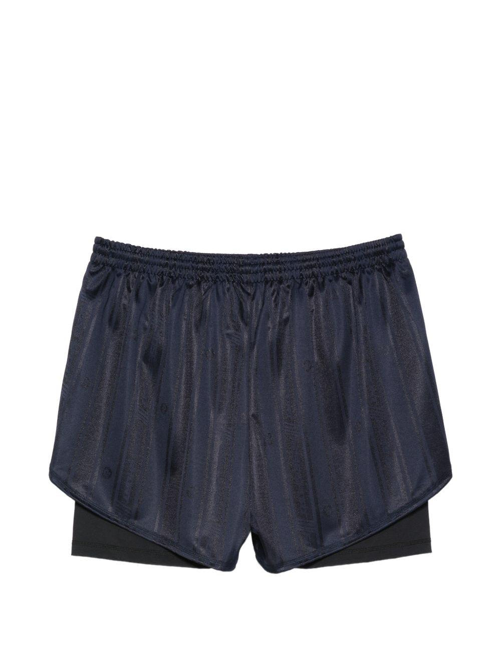 Pantaloncini con dettagli a righe in blu Martine rose - unisex 