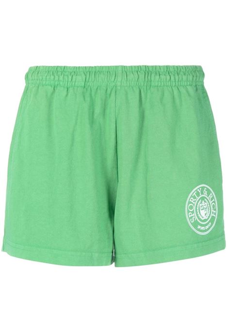 Pantaloncini sportivi con logo ricamato in verde - donna
