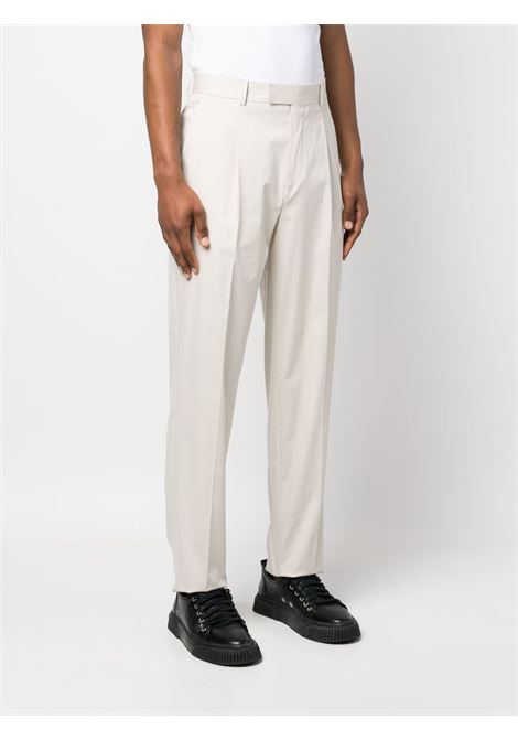 Pantaloni a gamba ampia con pieghe in beige - uomo ZEGNA | 77PM12515F00A5