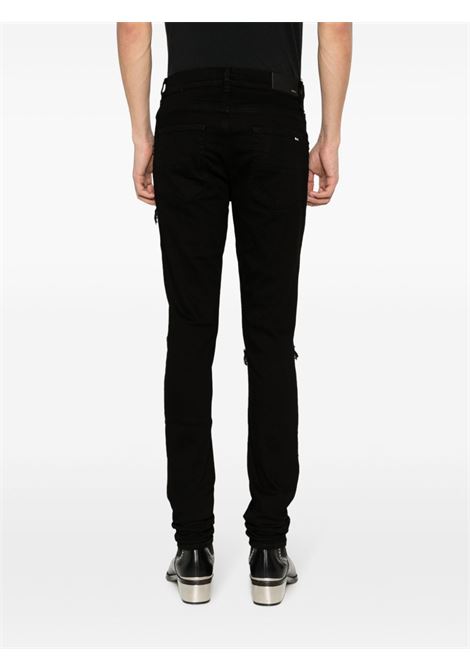 Jeans skinny MX1 con effetto vissuto in nero Amiri - uomo AMIRI | PXMD001BLK