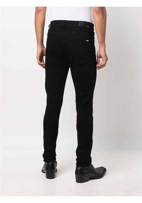 Jeans skinny con applicazione in nero Amiri - uomo AMIRI | PXMD002BLK